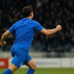 Konstantinos Karetsas van KRC Genk viert na een actie in een wedstrijd